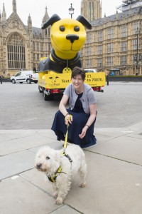 Alison Thewliss petting a dog at the launch of the Dogs Trust ad campaign