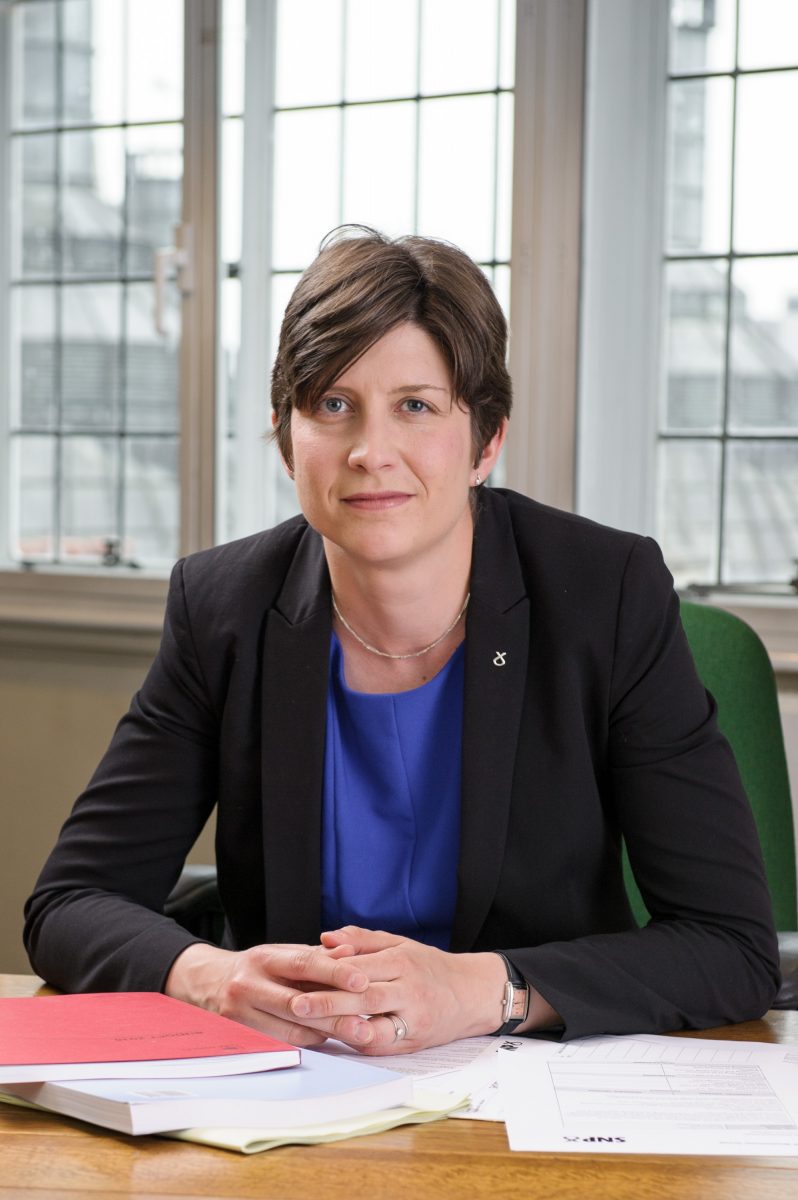 Alison Thewliss MP sitting at her desk in Parliament